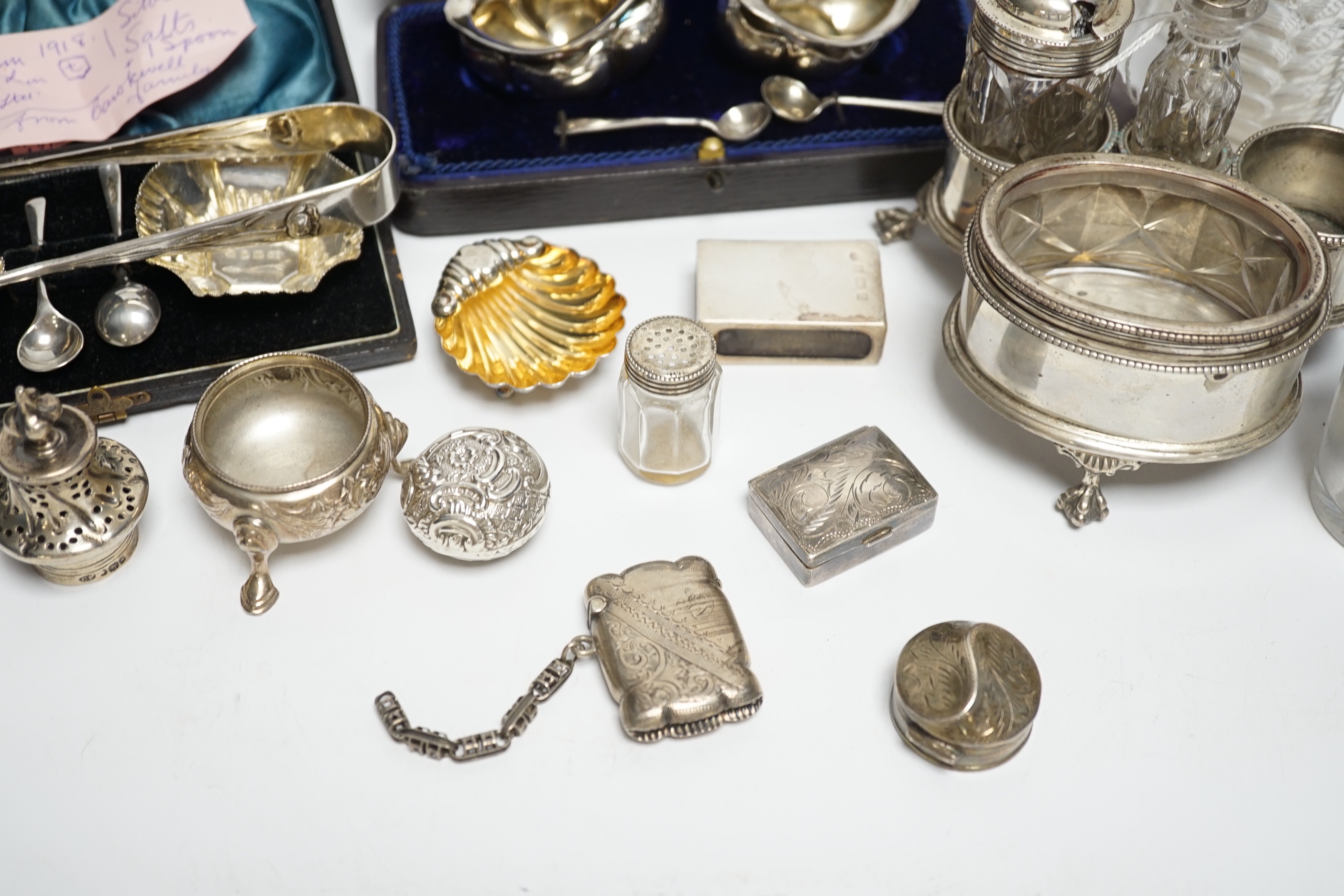 Sundry small silver including a Victorian silver cruet stand, London, 1858 (lacking one bottle), two salts, a vesta case, pill boxes, pair of sugar tongs, two cased pairs of salts with spoons, five mounted glass bottles,